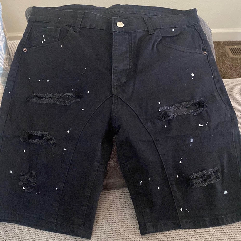 I am selling these black with white paint splatters ripped Jean shorts size 34